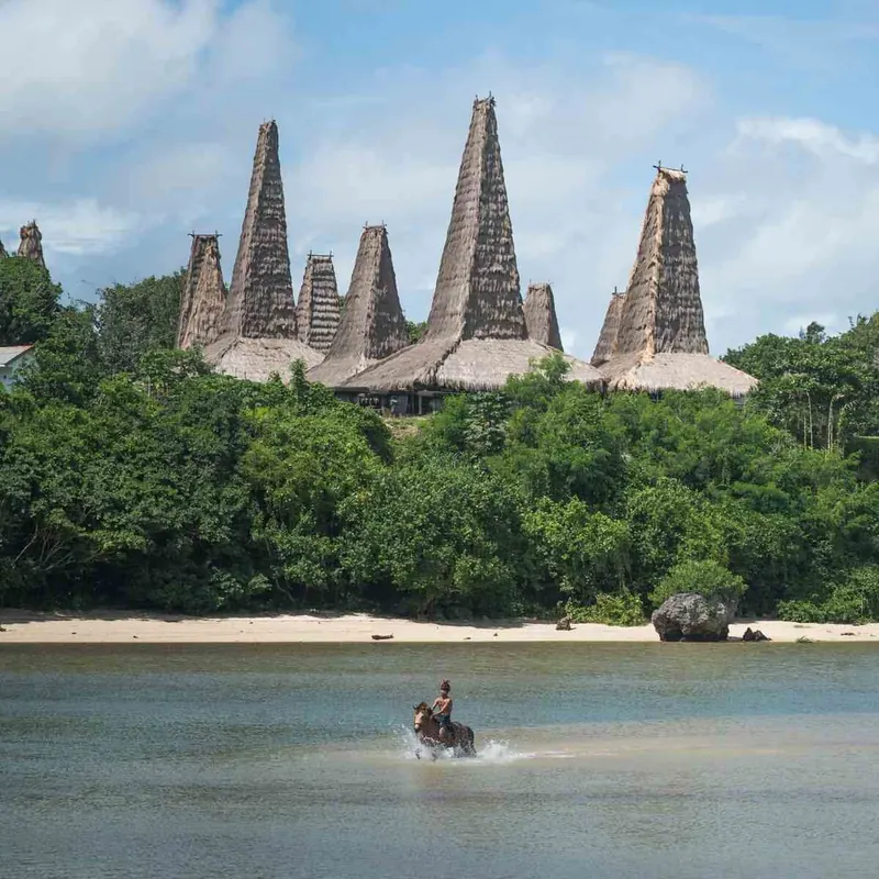 Thatched roof towers of Ratenggaro Traditional Village above the water