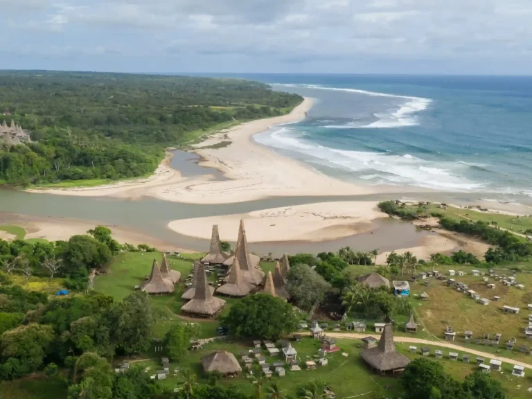 Aerial view of Ratenggaro traditional village and the surf-lined river mouth in Southwest Sumba