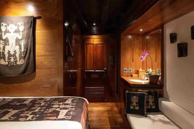Wood-panelled guest cabin aboard the Silolona phinisi